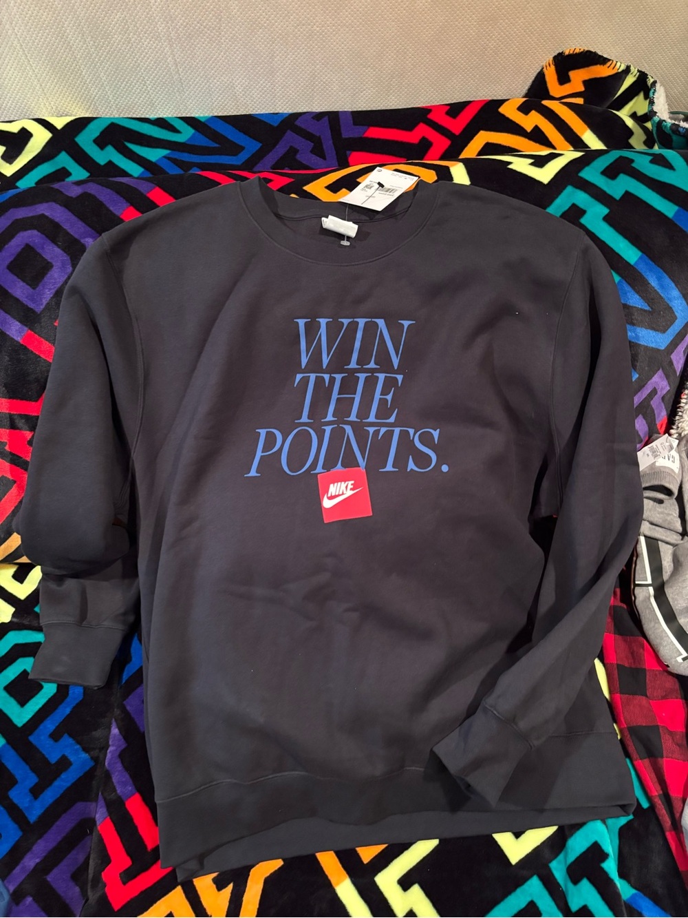 Nike Black Crewneck Sweatshirt with Blue 'WIN THE POINTS.' Graphic and Red Logo
